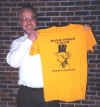 Dr. Gregg Andrews, Professor of History at Southwest Texas State University, is presented with a Mark Twain Forum t-shirt.